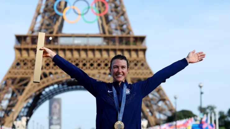 Kristen Faulkner holds her gold medal beneath the Eiffel Tower